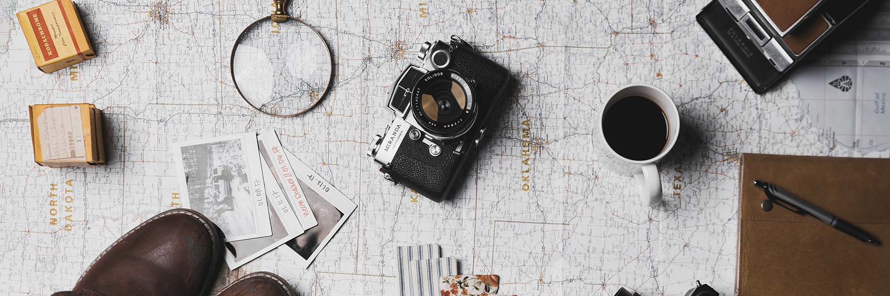 Picture of a Map with a camera and magnifying glass on top for cultural immersion