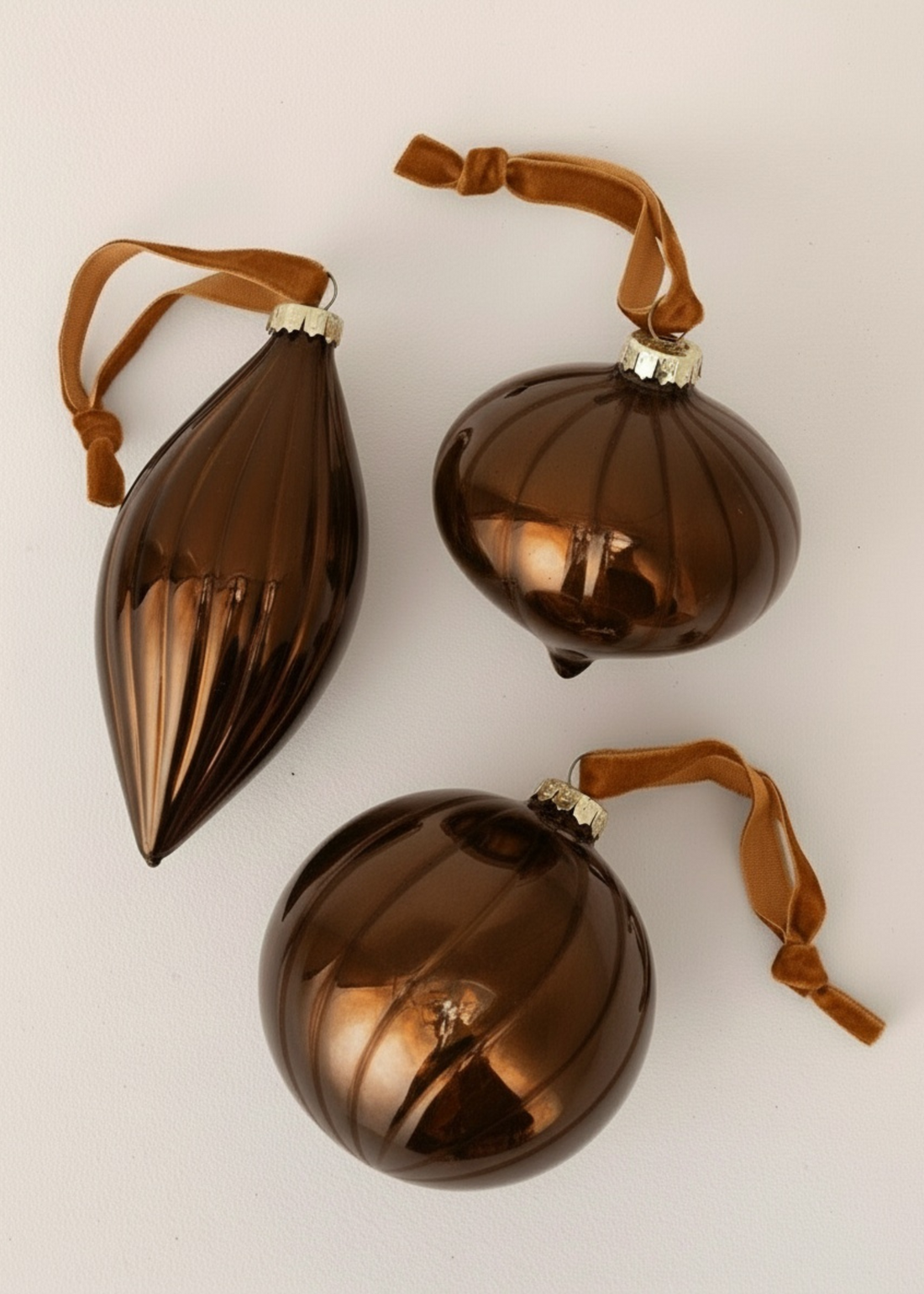 TRULY LIFESTYLE SET OF THREE MOCHA COLOURED GLASS CHRISTMAS DECORATIONS ON NEUTRAL BACKGROUND