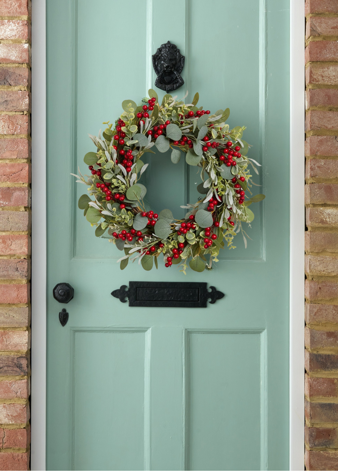 TRULY LIFESTYLE RED BERRY WREATH HANGING ON A DOOR