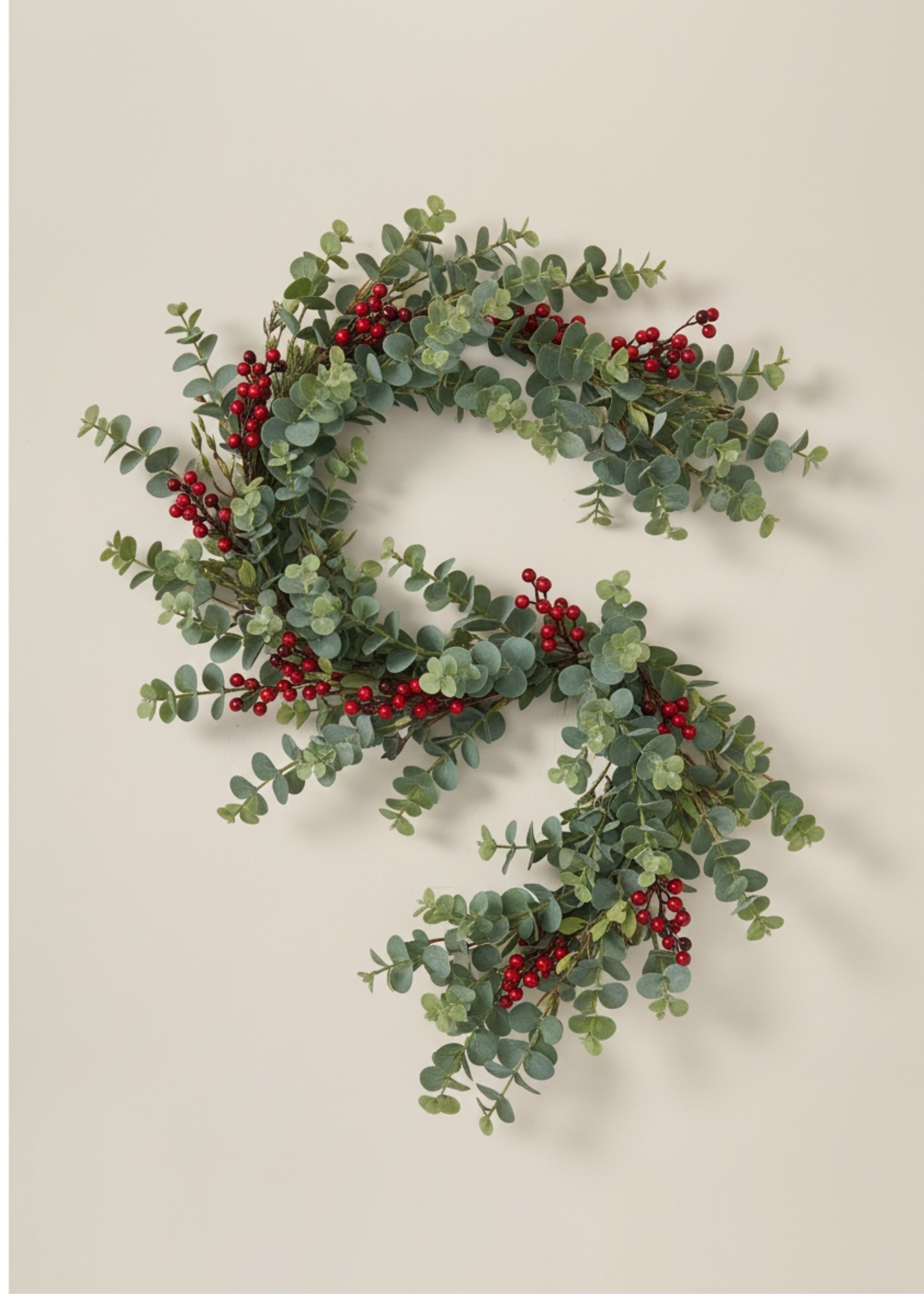 Truly Lifestyle Christmas Two green wreaths with red berries on a beige background