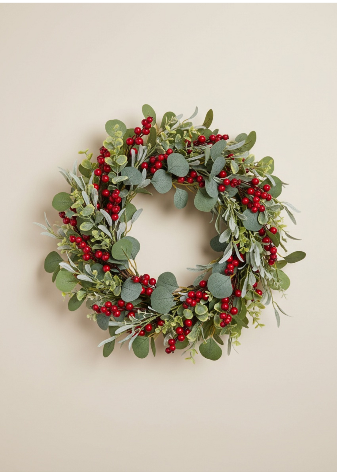 TRULY LIFESTYLE CHRISTMAS Decorative wreath with green leaves and red berries on a beige background