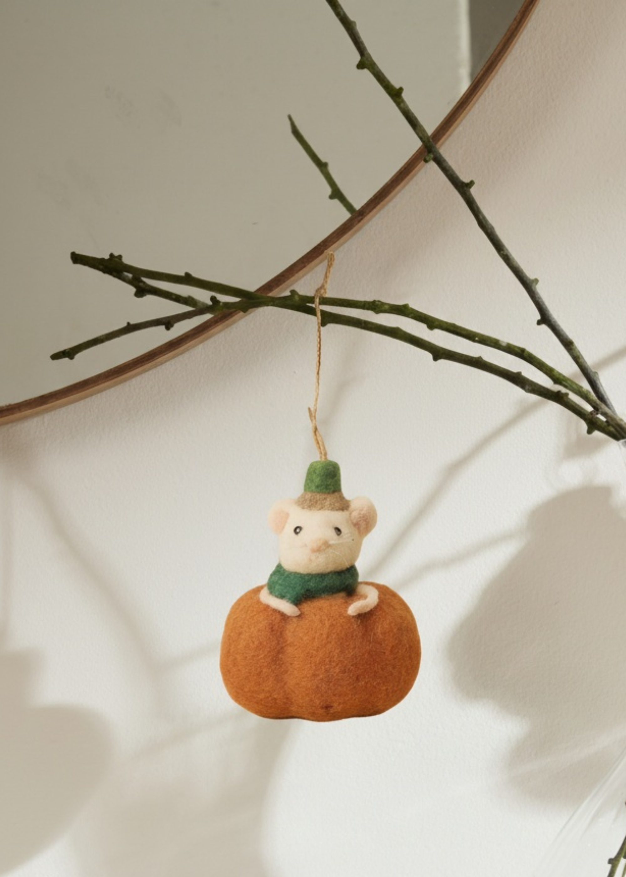 Felted mouse on a pumpkin hanging from a branch by Truly Lifestyle
