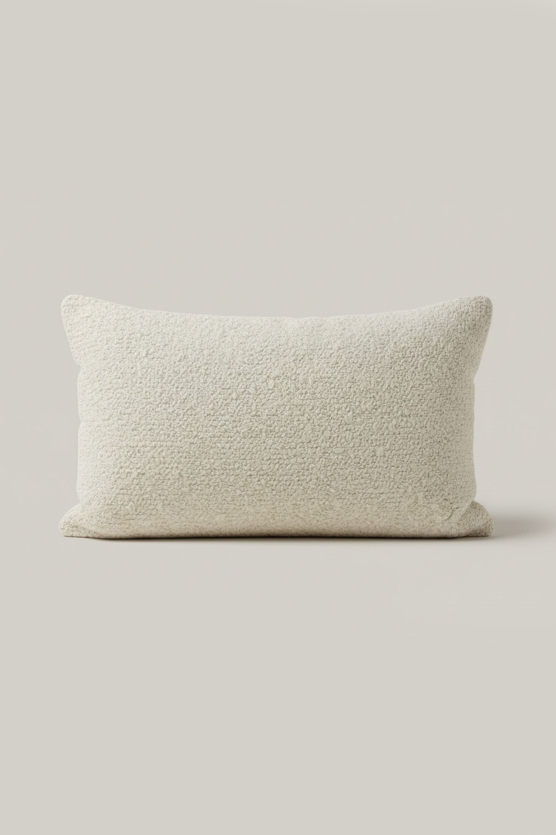Textured beige pillow on a light gray background