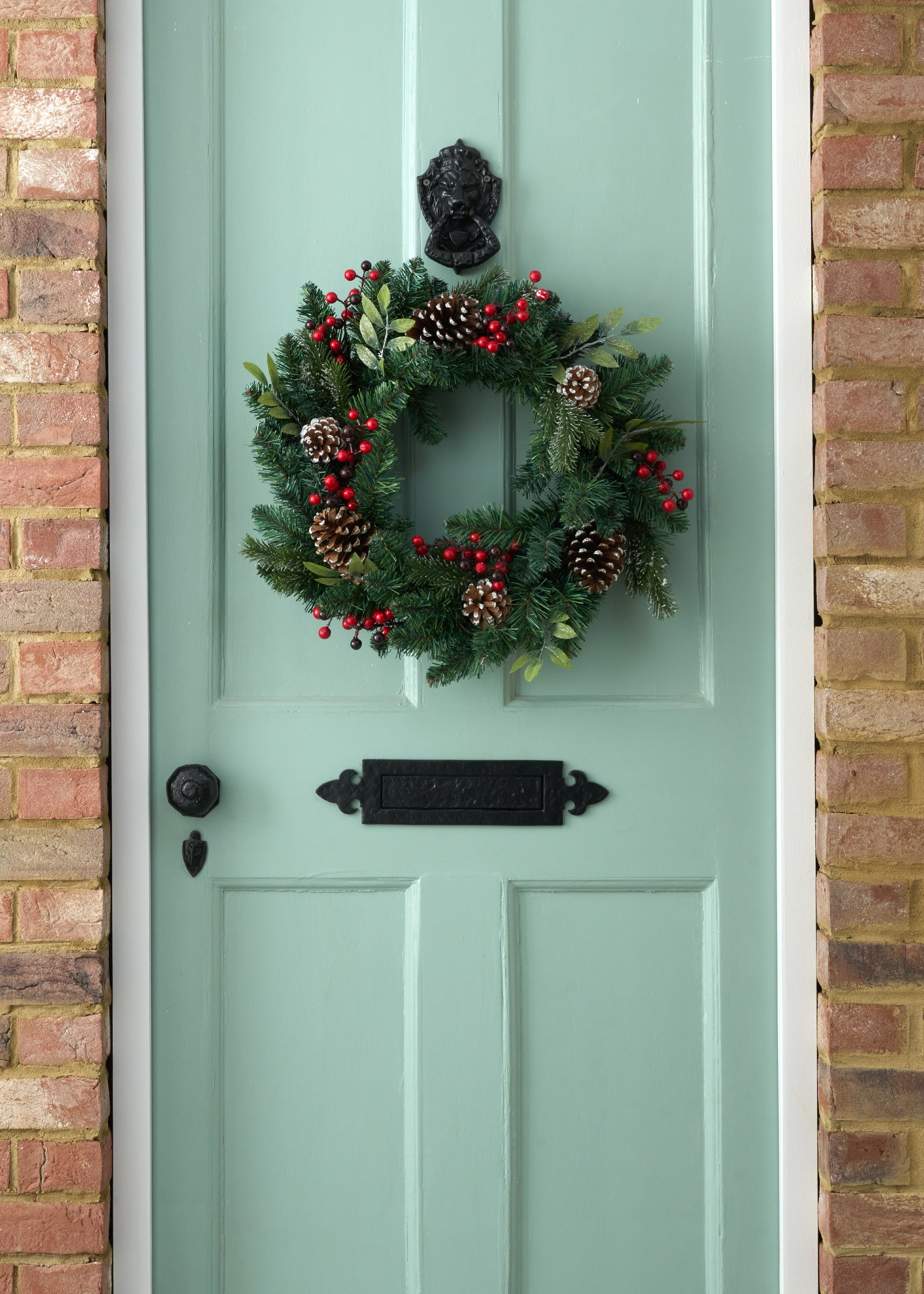 TRULY LIFESTYLE GREEN CHRISTMAS WREATH WITH RED BERRIES AND PINECONES ON DOOR