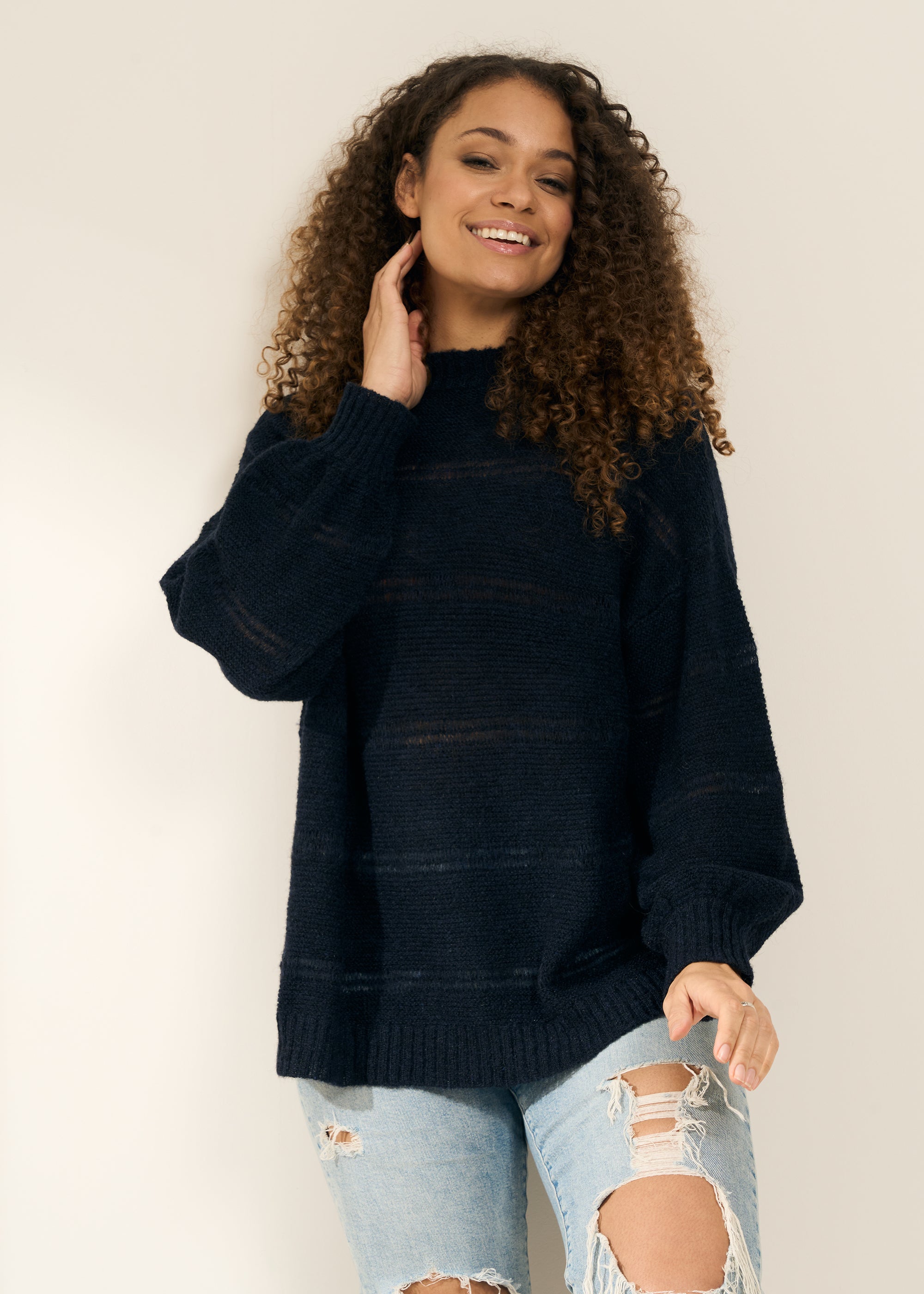 TRULY LIFESTYLE WOMENS NAVY OPEN KNIT JUMPER ON MODEL WITH JEANS
