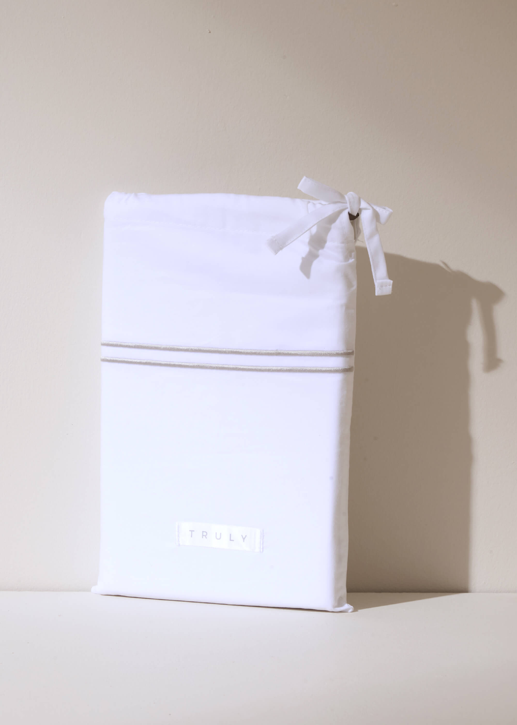WHITE SATIN HOUSEWIFE PILLOWCOVERS WITH GREY STITCH DETAIL IN WHITE DUST BAG | TRULY LIFESTYLE