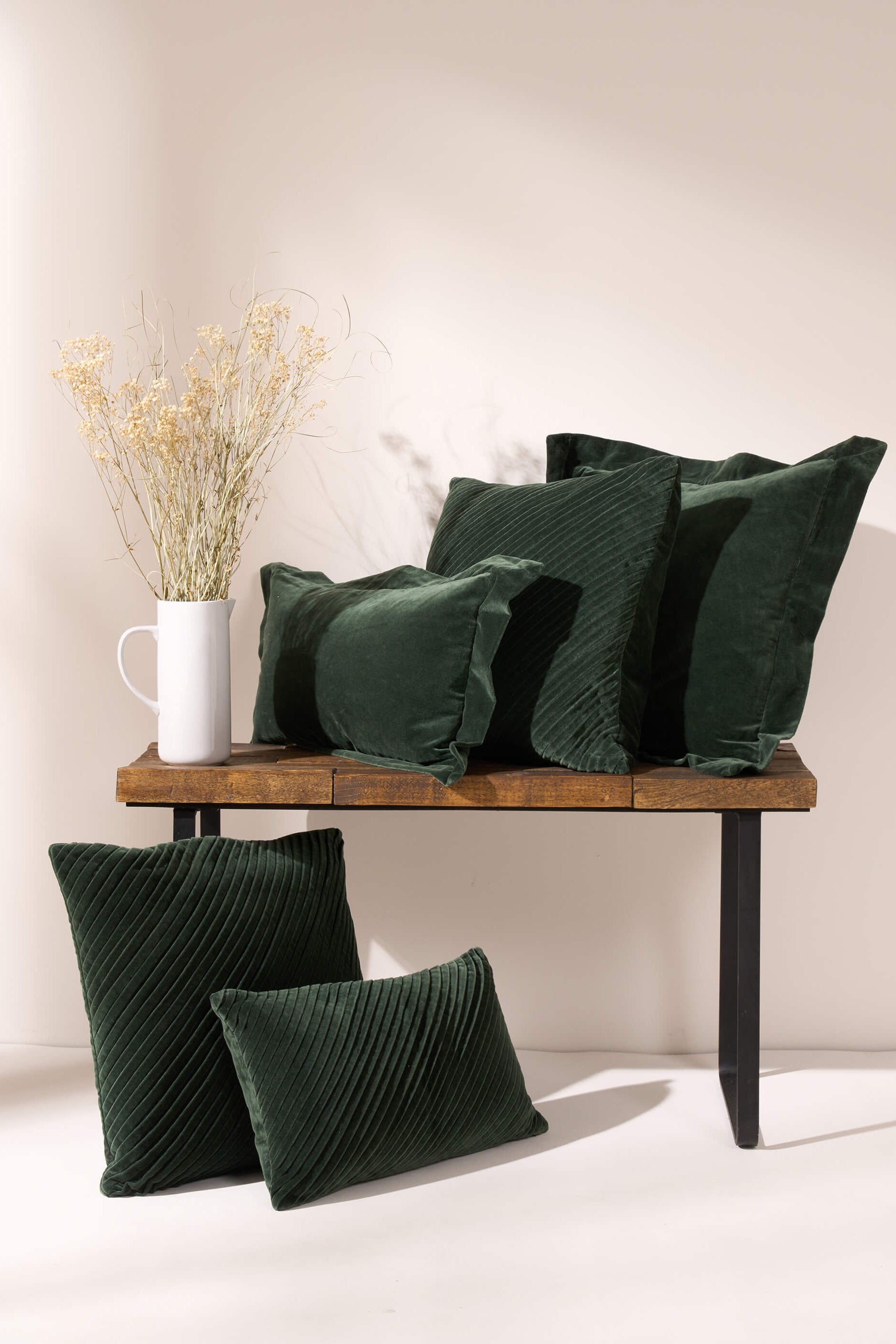 TRULY LIFESTYLE EMERALD VELVET COLLECTION OF CUSHIONS ON A BENCH WITH DRIED FLOWERS