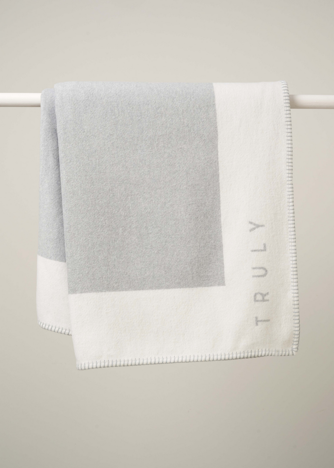 GREY RECYCLED COTTON BLANKET HANGING ON RAIL | TRULY LIFESTYLE