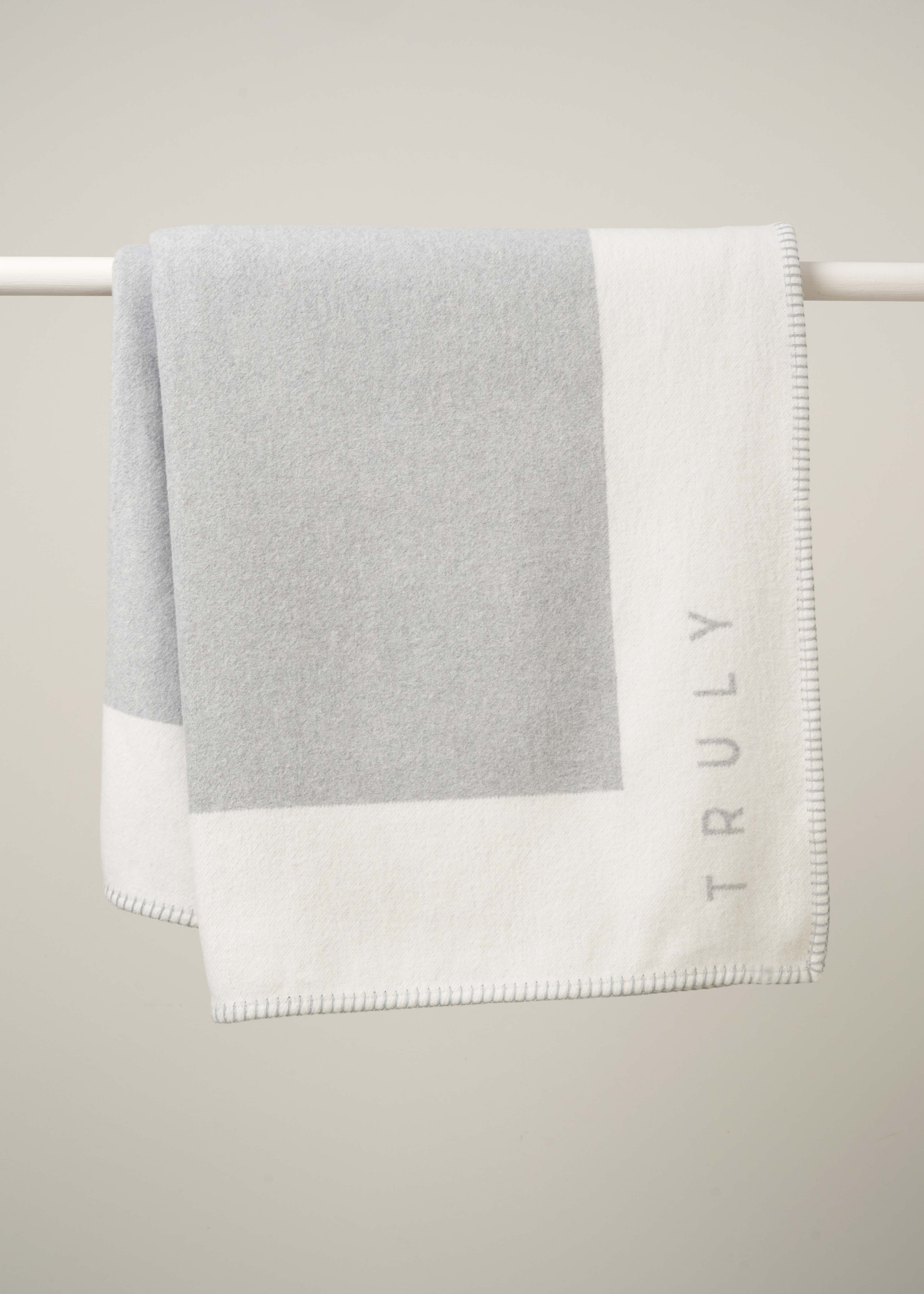 GREY RECYCLED COTTON BLANKET HANGING ON RAIL | TRULY LIFESTYLE