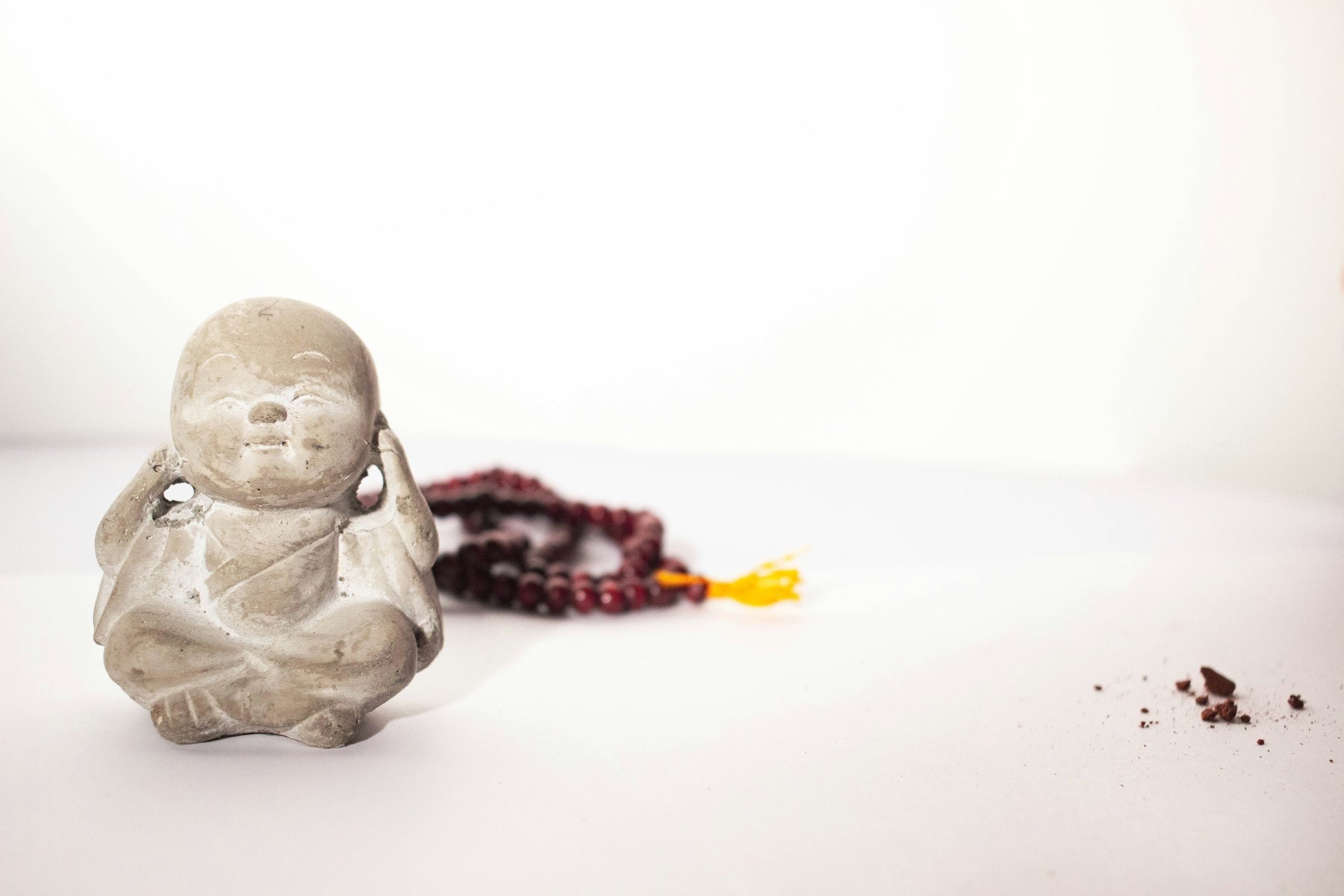 Buddha statue with prayer beads for self care 