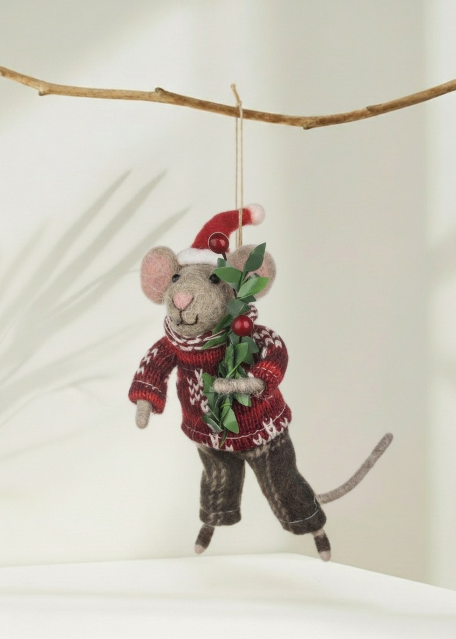 Truly Lifestyle Christmas Felted mouse ornament wearing a sweater and Santa hat, hanging from a branch.