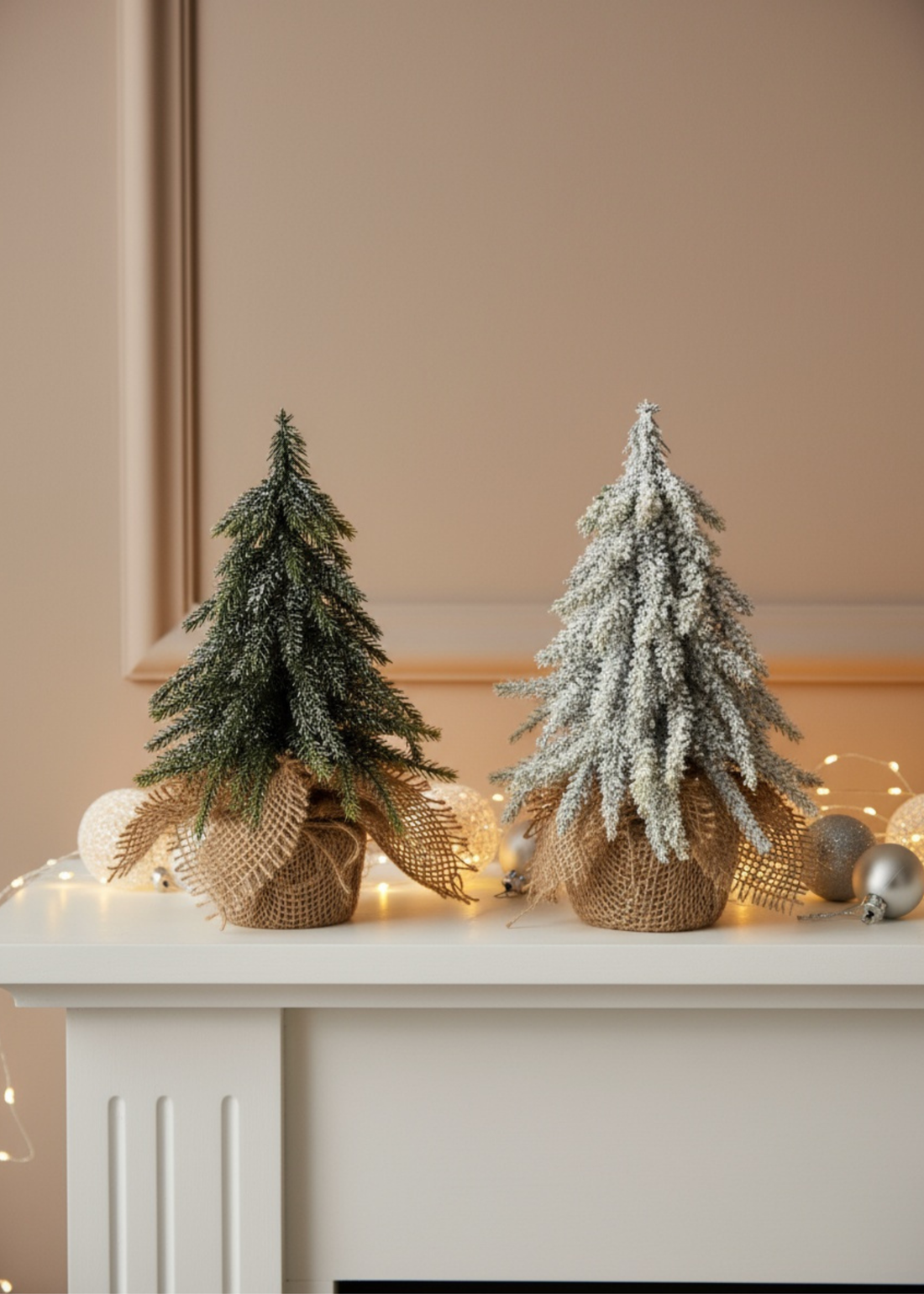 Truly Lifestyle Two small Christmas trees on a mantelpiece with decorative ribbons and lights.