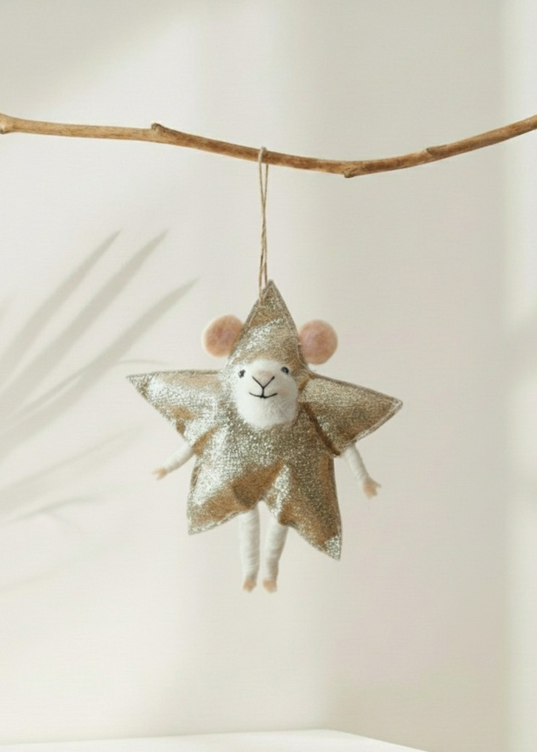 truly lifestyle Decorative christmas mouse ornament with star-shaped body hanging from a branch against a neutral background