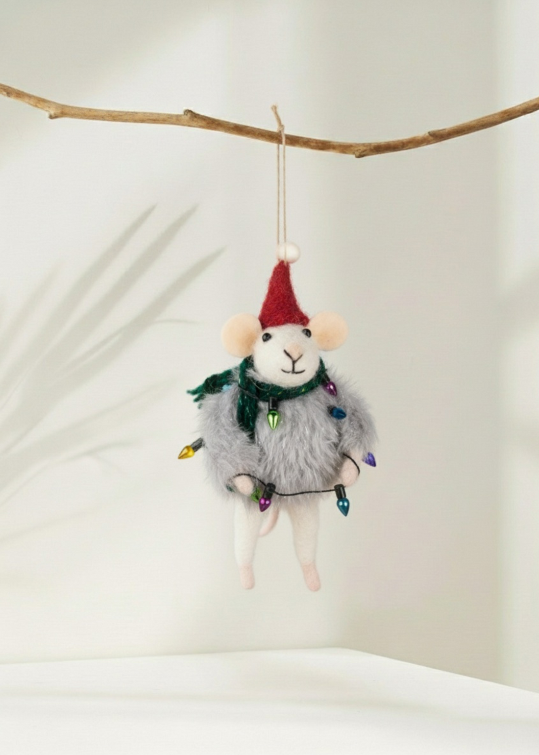 Truly Lifestyle Decorative mouse christmas decoration with a Santa hat and string lights hanging from a branch.
