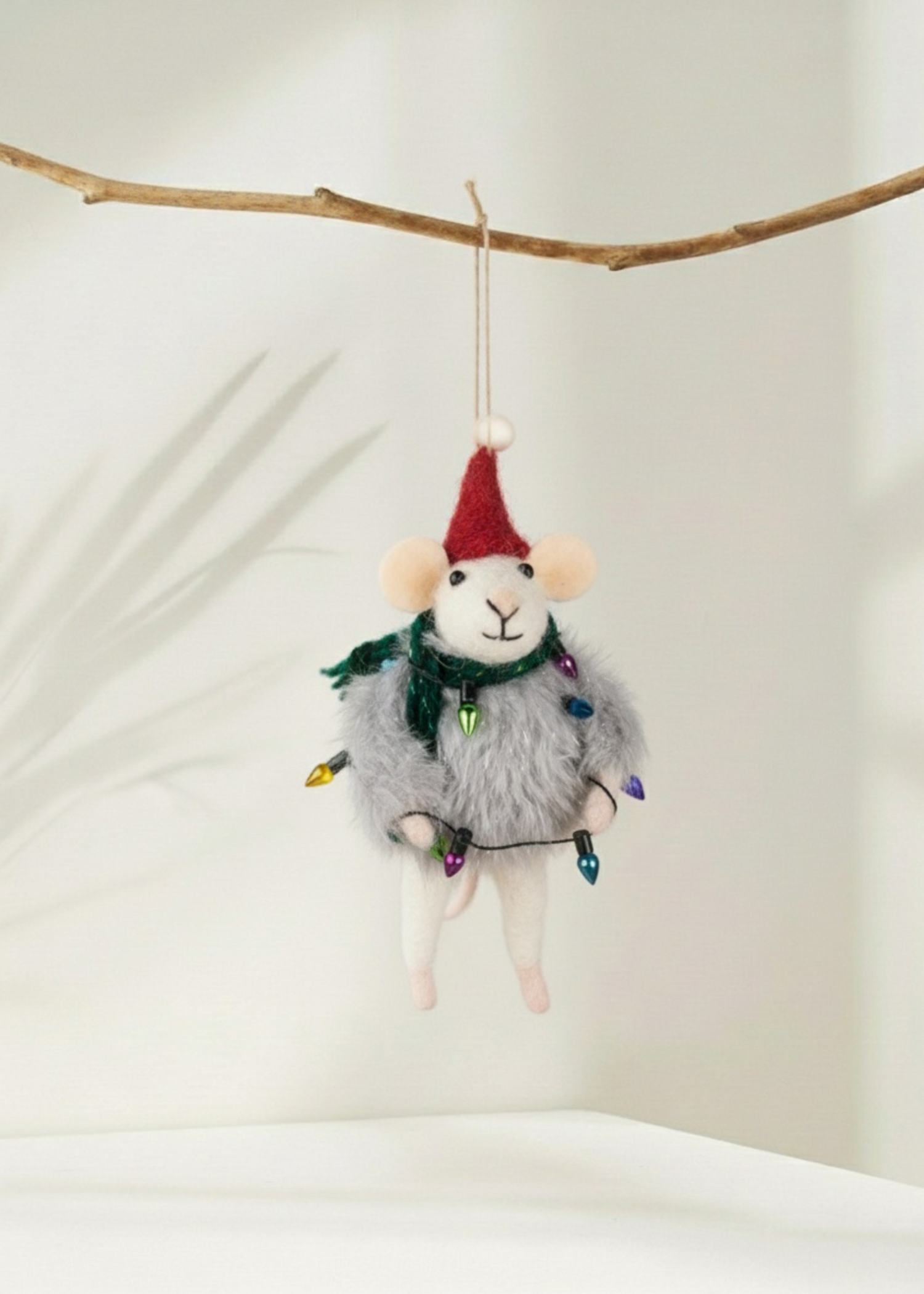 Truly Lifestyle Decorative mouse christmas decoration with a Santa hat and string lights hanging from a branch.