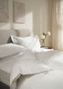 TRULY LIFESTYLE EMBROIDERED EDGE WHITE DUVET COVER ON BED FOLDED OVER