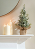truly lifestyle eucalyptus christmas tree next to candles
