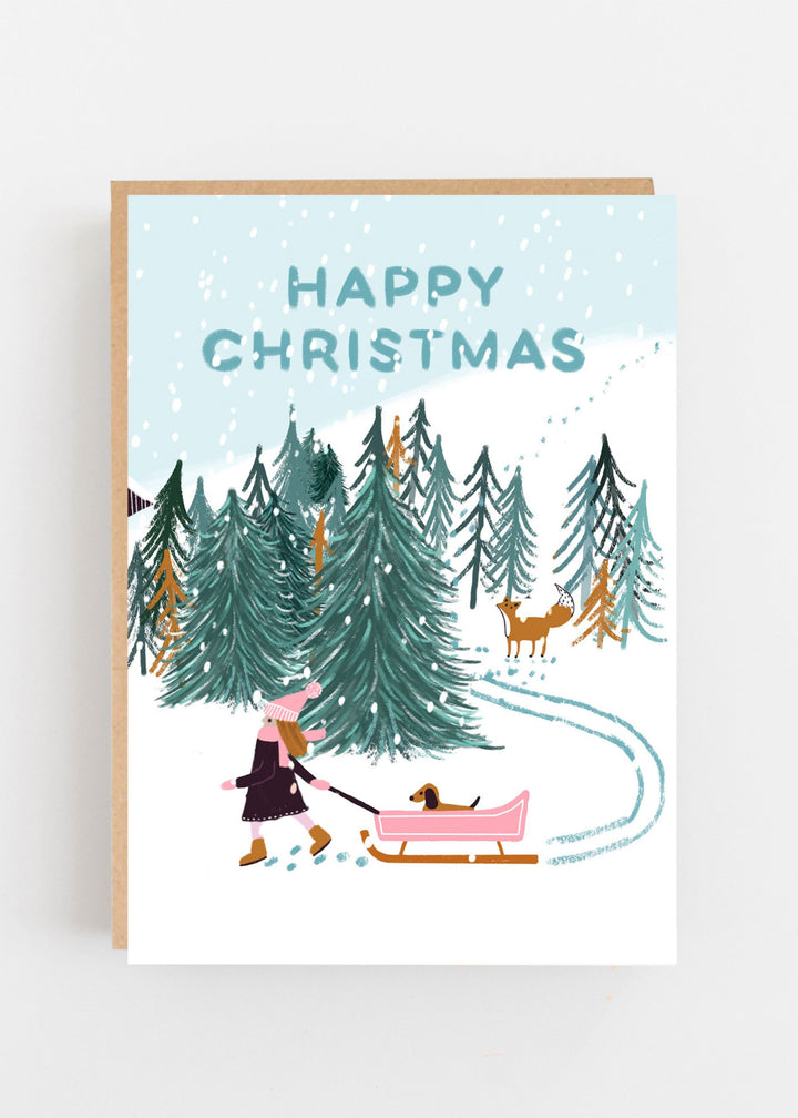 Happy Christmas Patterned Card With Christmas Trees, Snow and a Girl pulling a sledge