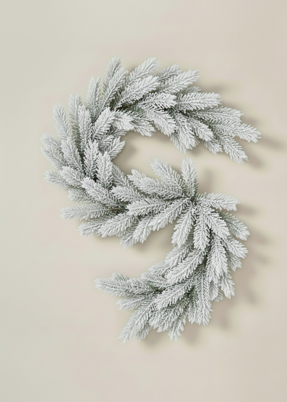 TRULY LIFESTYLE Two snow-frosted wreaths on a beige background