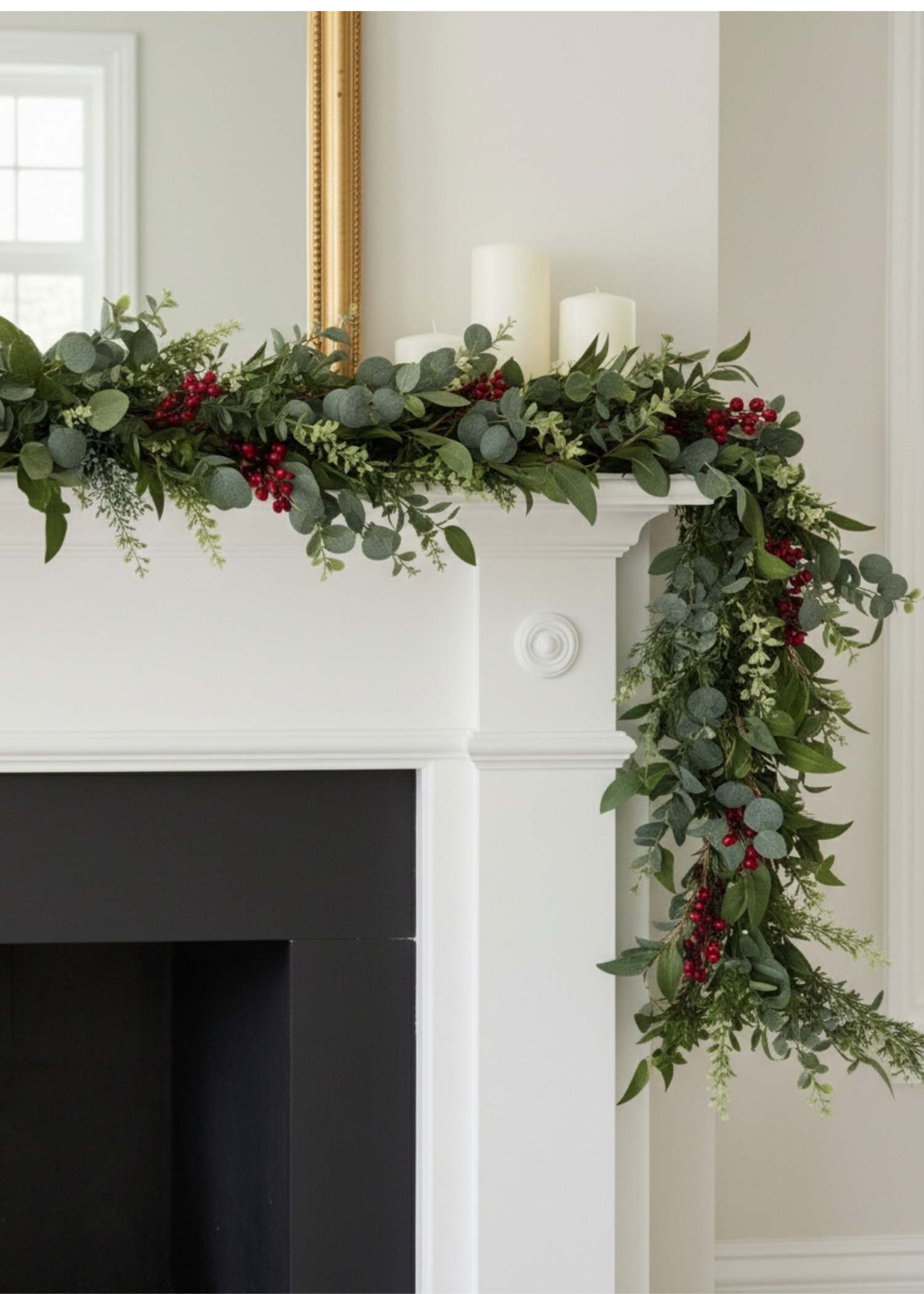 Truly Lifestyle Christmas Greenery and red berry garland on a white fireplace mantel.