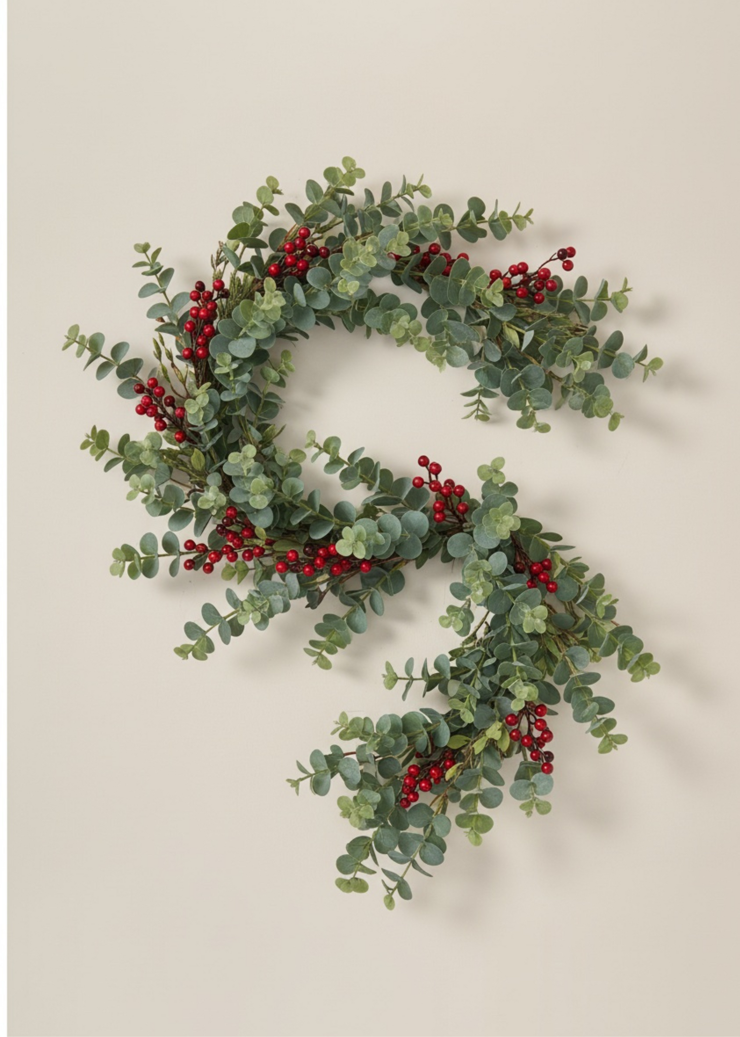 Truly Lifestyle Christmas Two green wreaths with red berries on a beige background