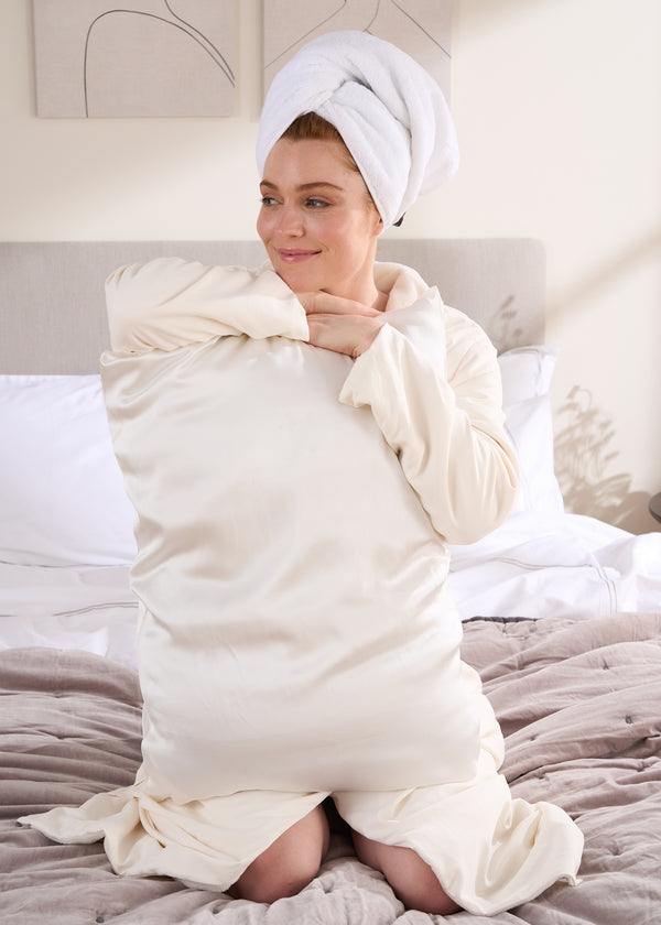 Truly Lifestyle Ivory Silk Pillowcase Being Held By Model