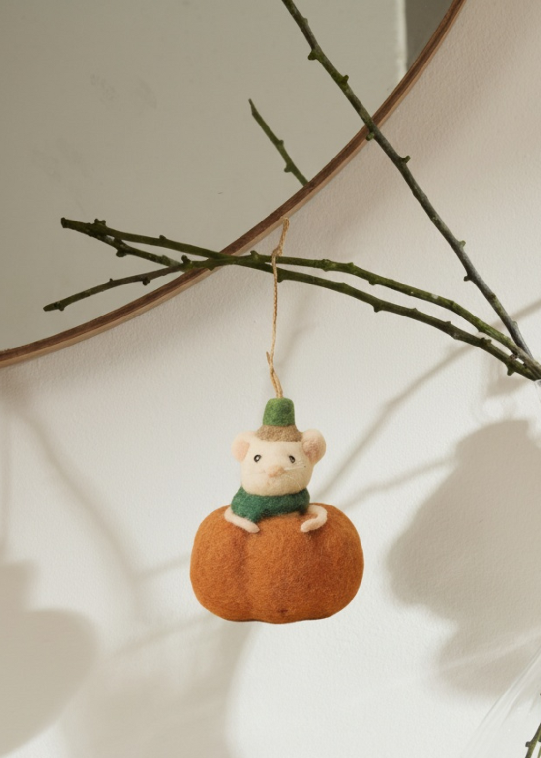 Felted mouse on a pumpkin hanging from a branch by Truly Lifestyle