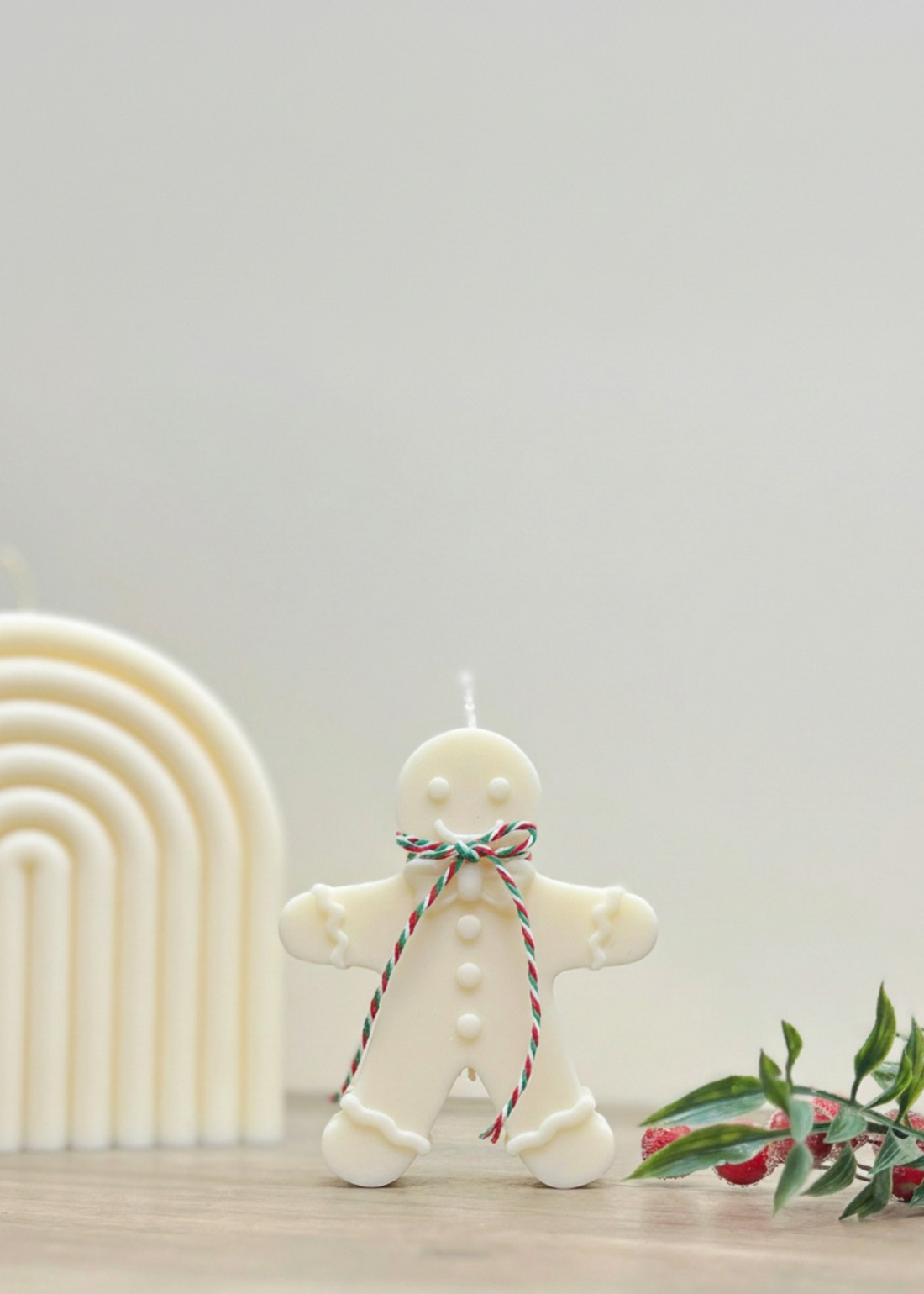 Truly Lifestyle Gingerbread man candle with a string of lights on a neutral background