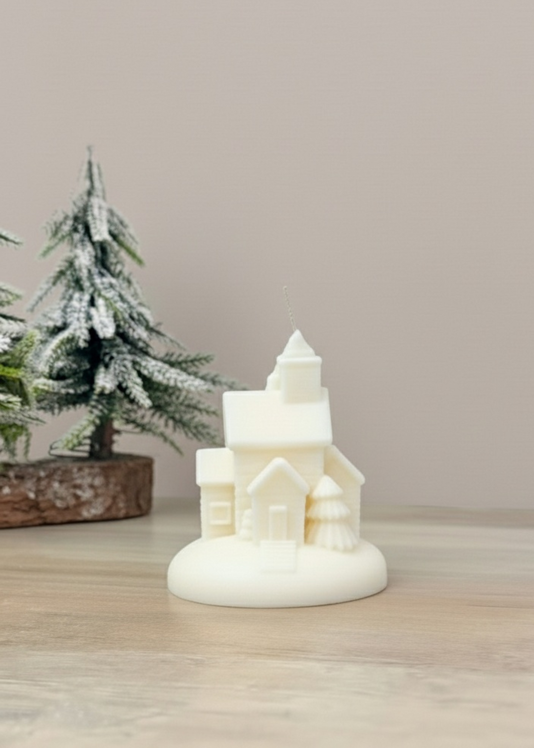 Truly Lifestyle Decorative candle shaped like a house with a Christmas tree in the background