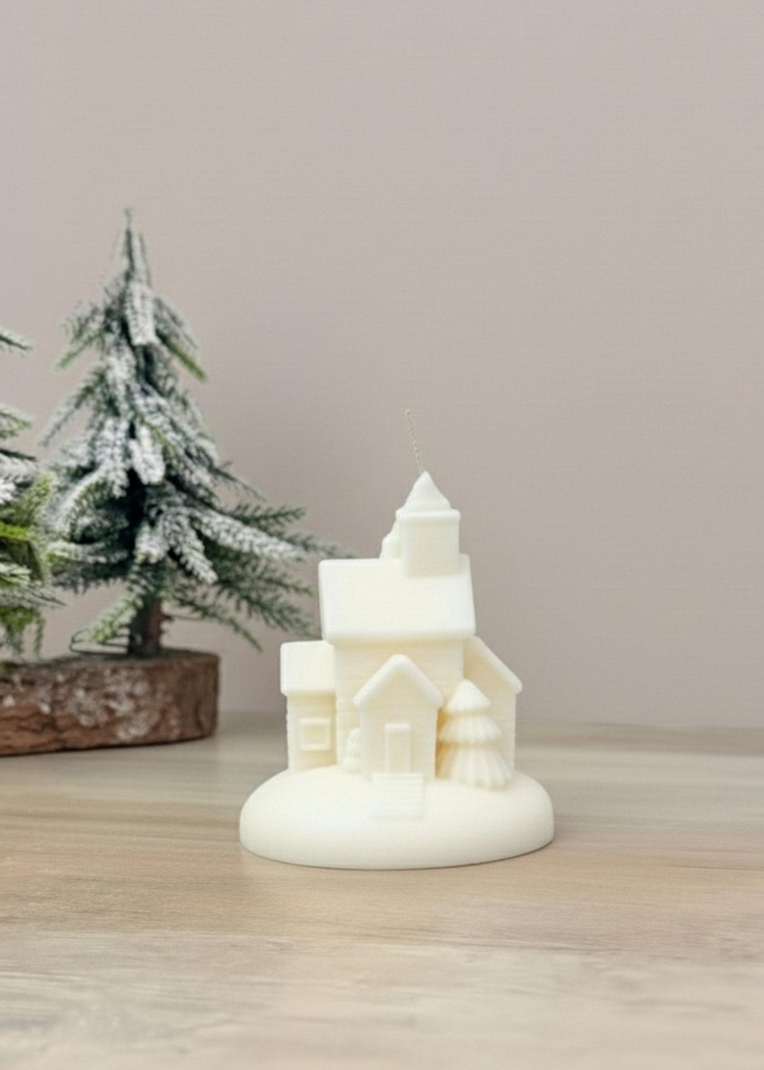 Truly Lifestyle Decorative candle shaped like a house with a Christmas tree in the background