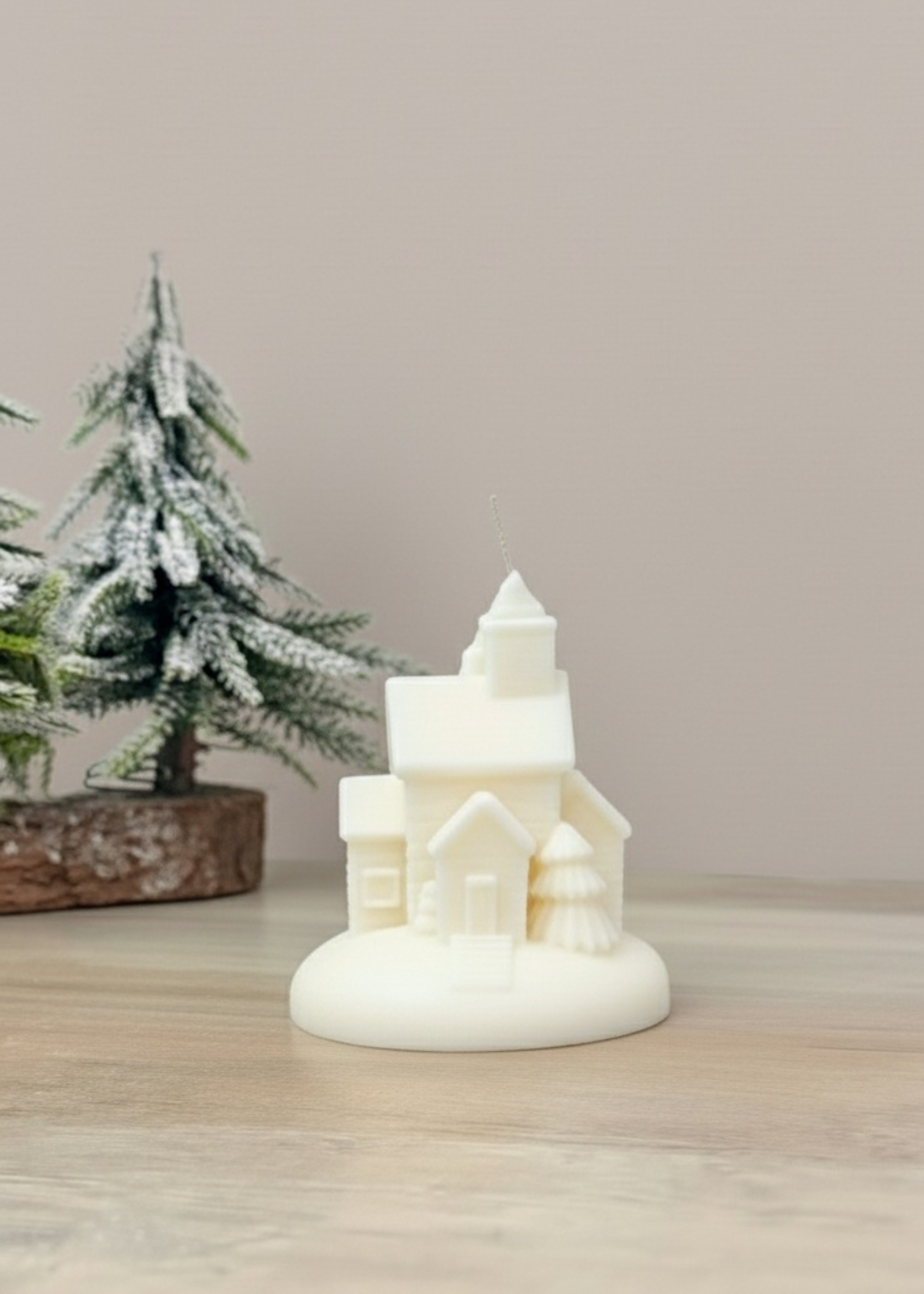 Truly Lifestyle Decorative candle shaped like a house with a Christmas tree in the background