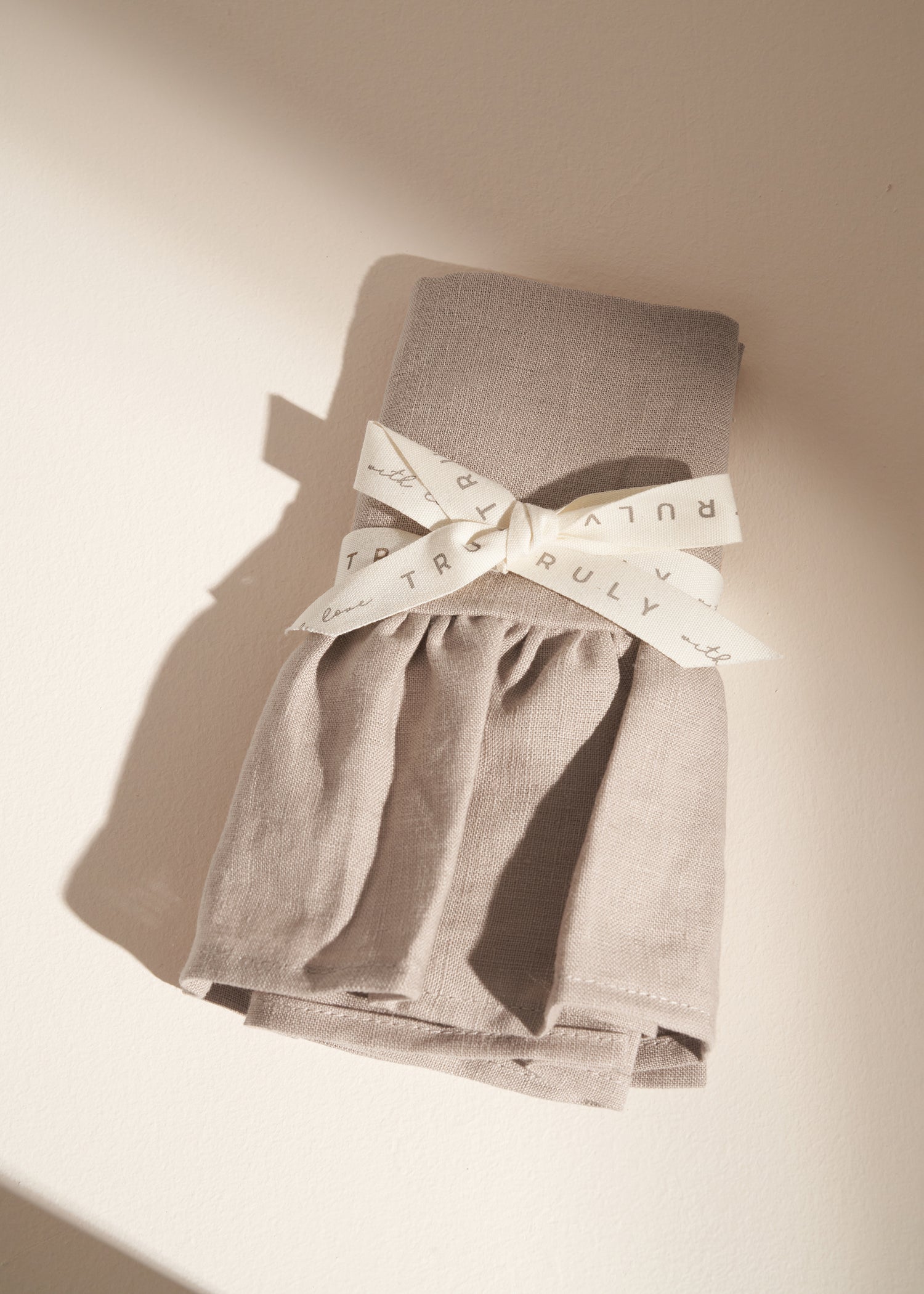 TRULY LIFESTYLE LINEN TEA TOWEL IN TAUPE  FOLDED