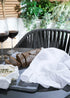truly lifestyle white linen tea towel
on garden table with brea