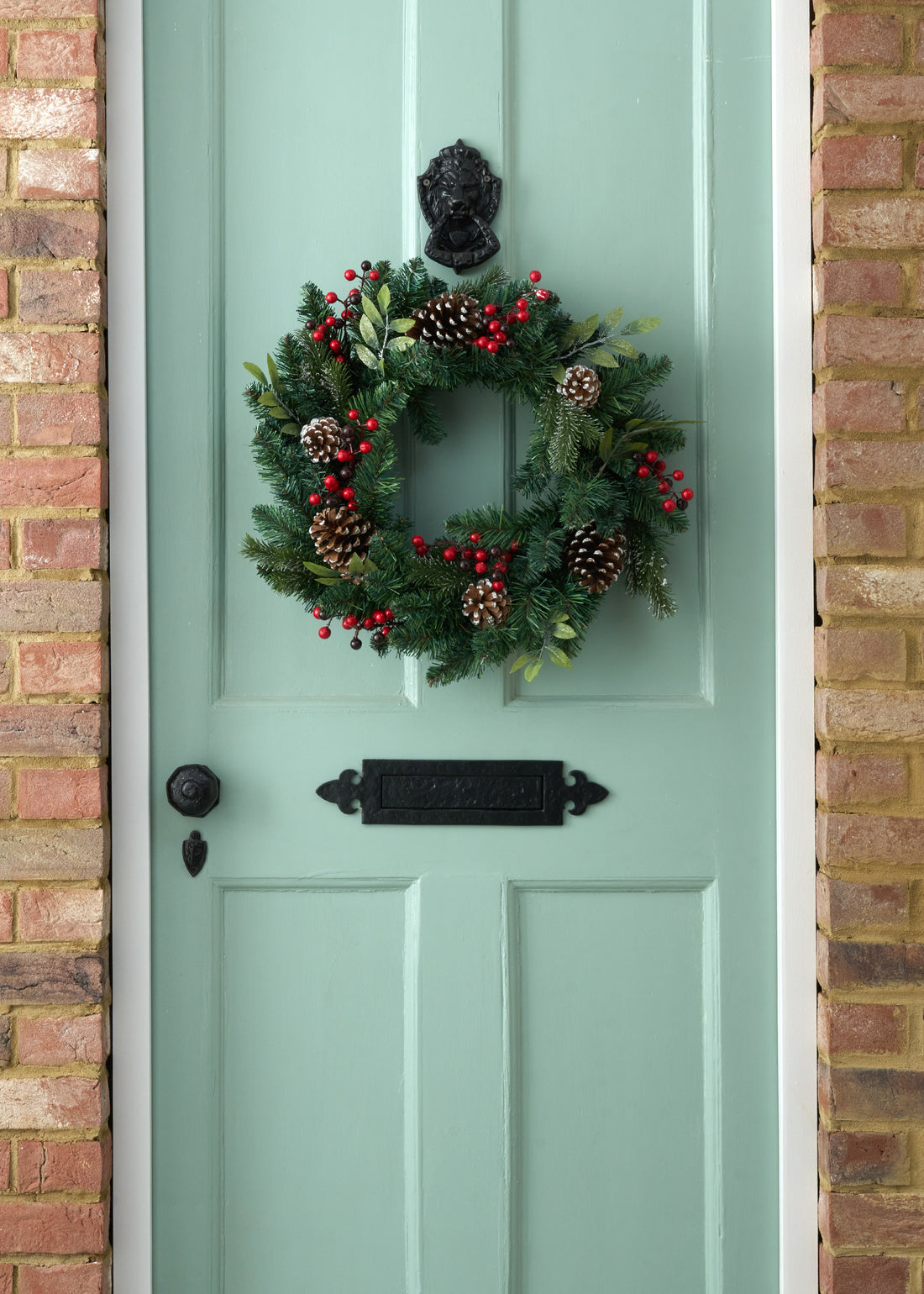 TRULY LIFESTYLE GREEN CHRISTMAS WREATH WITH RED BERRIES AND PINECONES ON DOOR