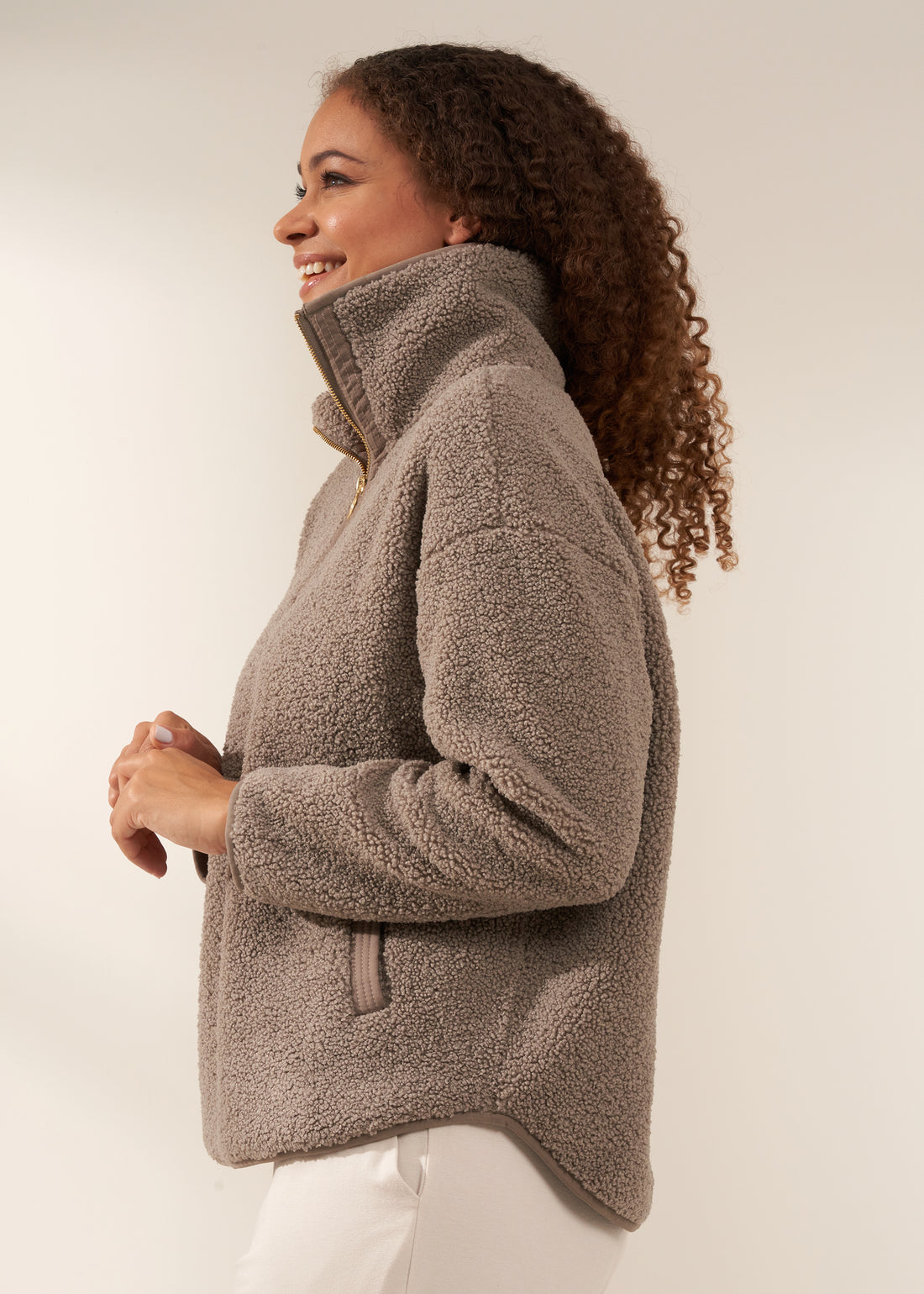 TRULY LIFESTYLE WOMENS OATMEAL BOUCLE QUARTER  ZIP JUMPER ON MODEL FROM THE SIDE WITH ECRU HAREEM JOGGING BOTTOMS