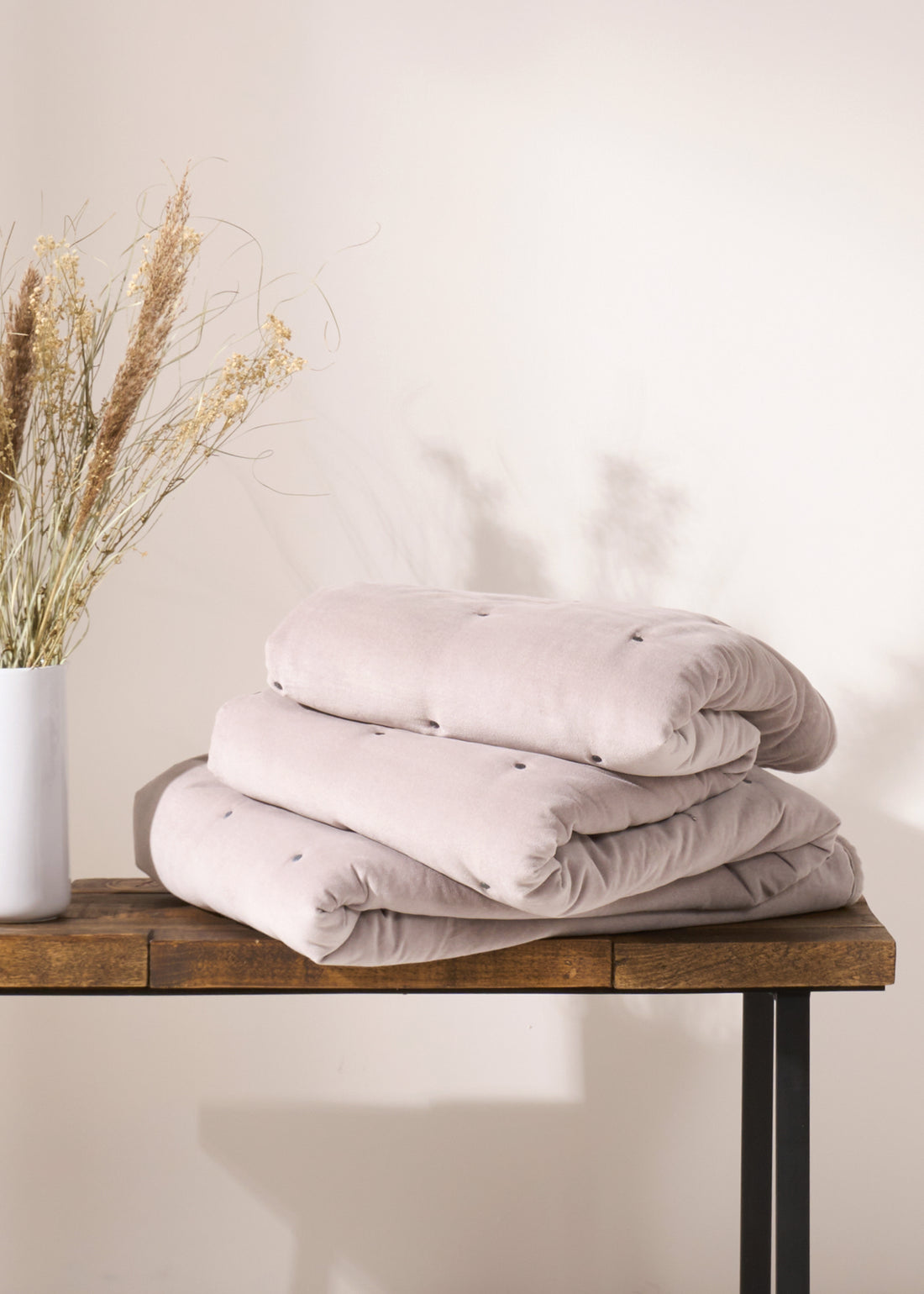 TRULY LIFESTYLE GREY QUILTED EIDERDOWN FOLDED ON A BENCH