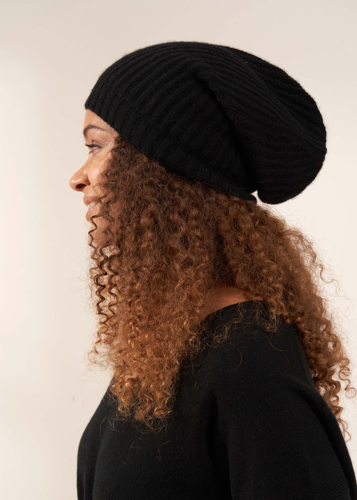 TRULY LIFESTYLE BLACK CASHMERE BEANIE HAT ON MODEL FROM THE SIDE
