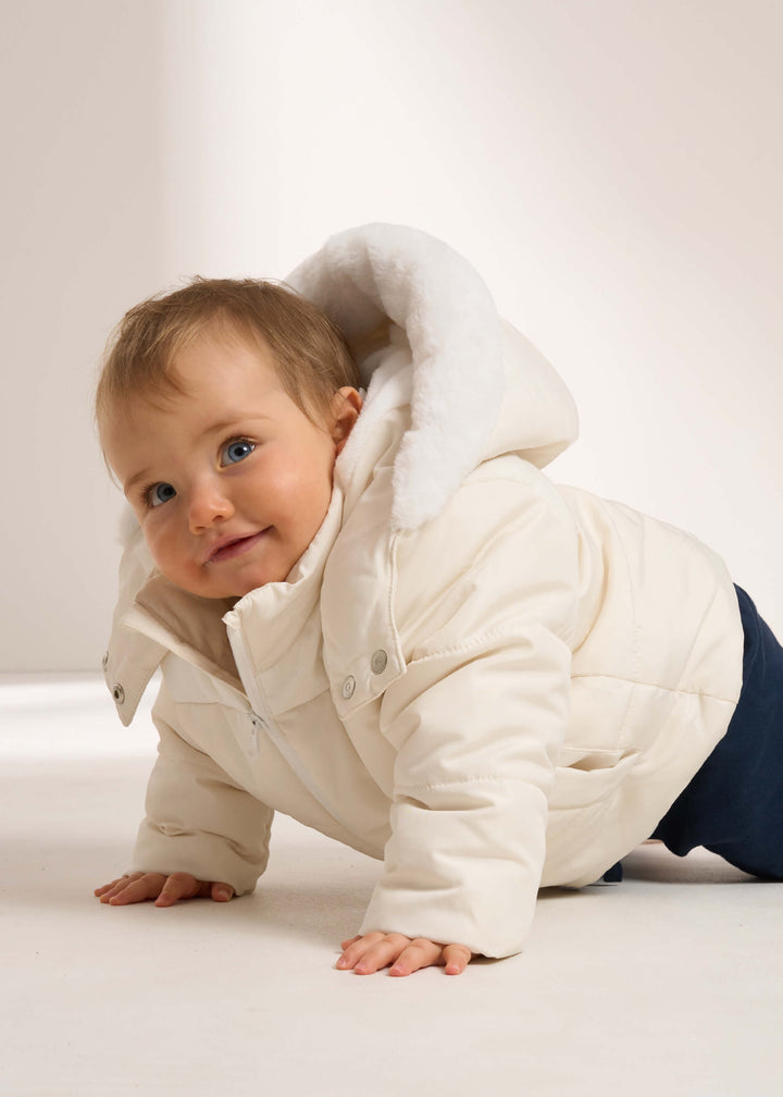 TRULY LIFESTYLE CREAM PADDED BABY COAT WITH FAUX FUR HOOD ON BABY WITH NAVY LEGGINGS