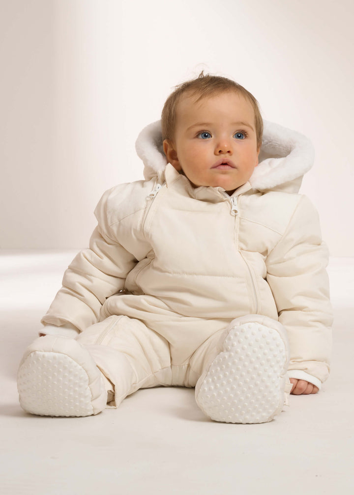Ivory Baby Snowsuit On Baby sitting Down | Truly Lifestyle