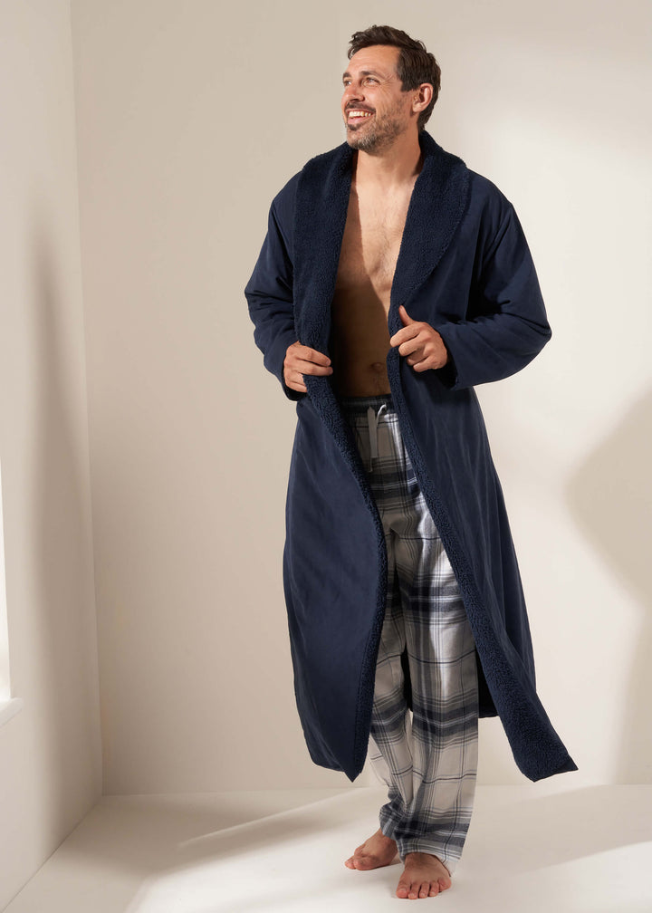 TRULY LIFESTYLE MENS MIDNIGHT BLUE FLEECE LINED DRESSING GOWN ON MODEL WITH CHECKED PYJAMA BOTTOMS