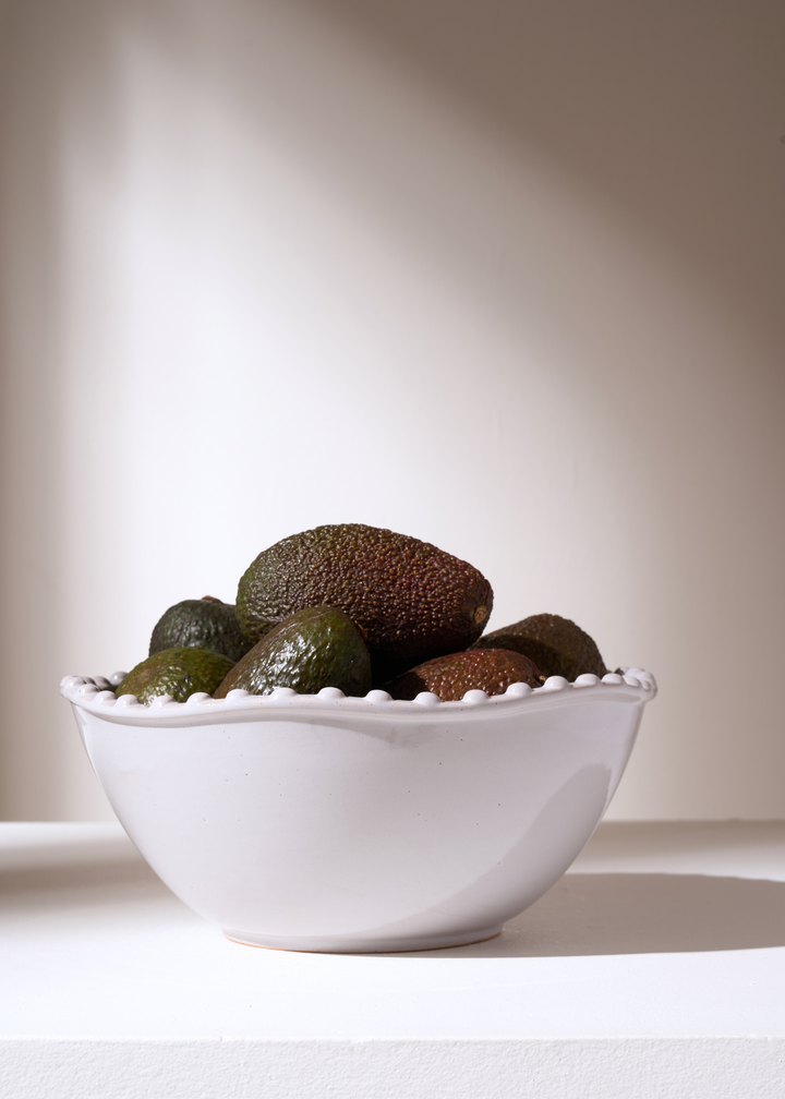 TRULY LIFESTYLE PALE GREY SMALL POM POM EDGED SERVING BOWL FILLED WITH AVOCADOS