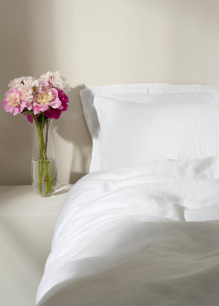 WHITE LINEN DUVET COVER ON BED WITH FLOWERS IN VASE| TRULY LIFESTYLE