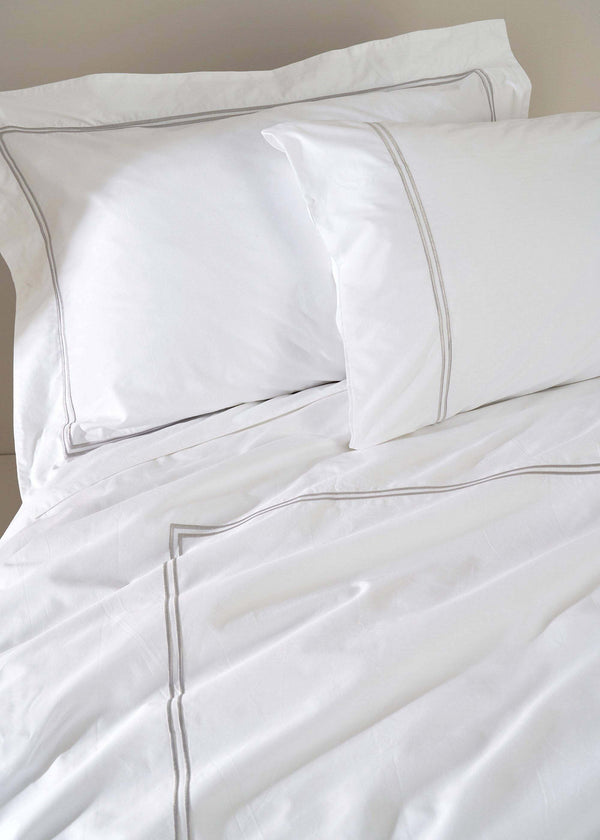 WHITE SATIN BEDDING WITH GREY STITCHING ON BED | TRULY LIFESTYLE