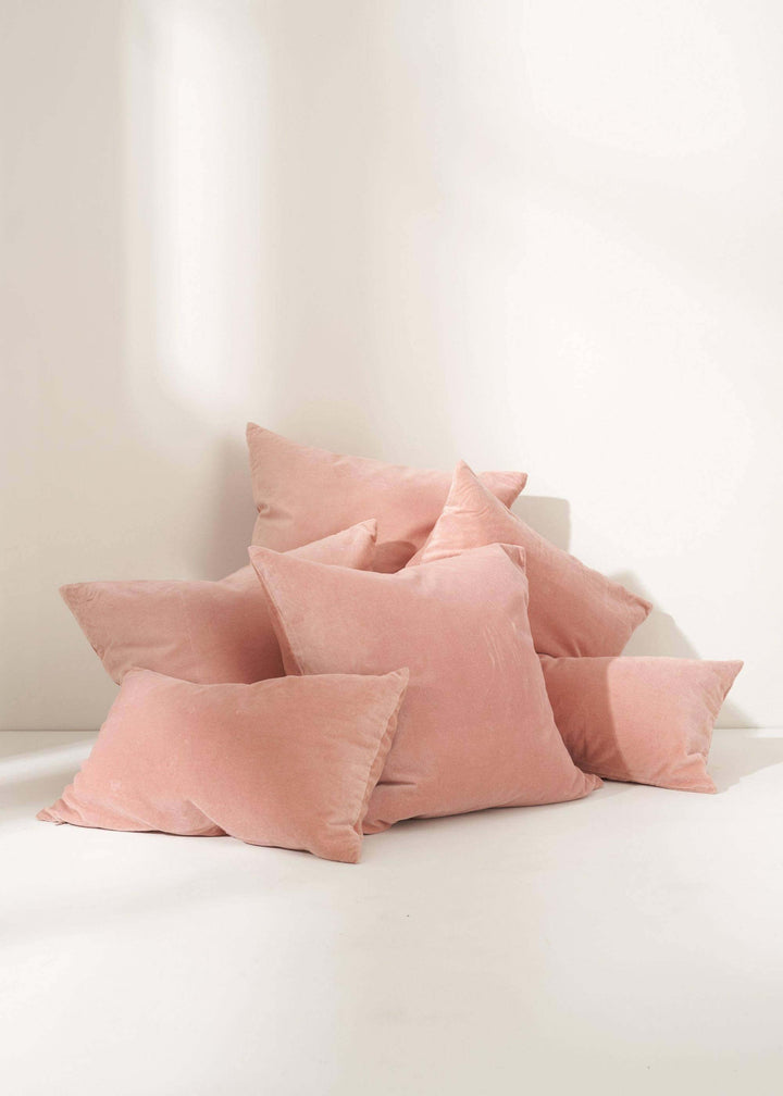 LIGHT PINK SQUARE VELVET GROUP OF CUSHIONS ON FLOOR | TRULY LIFESTYLE