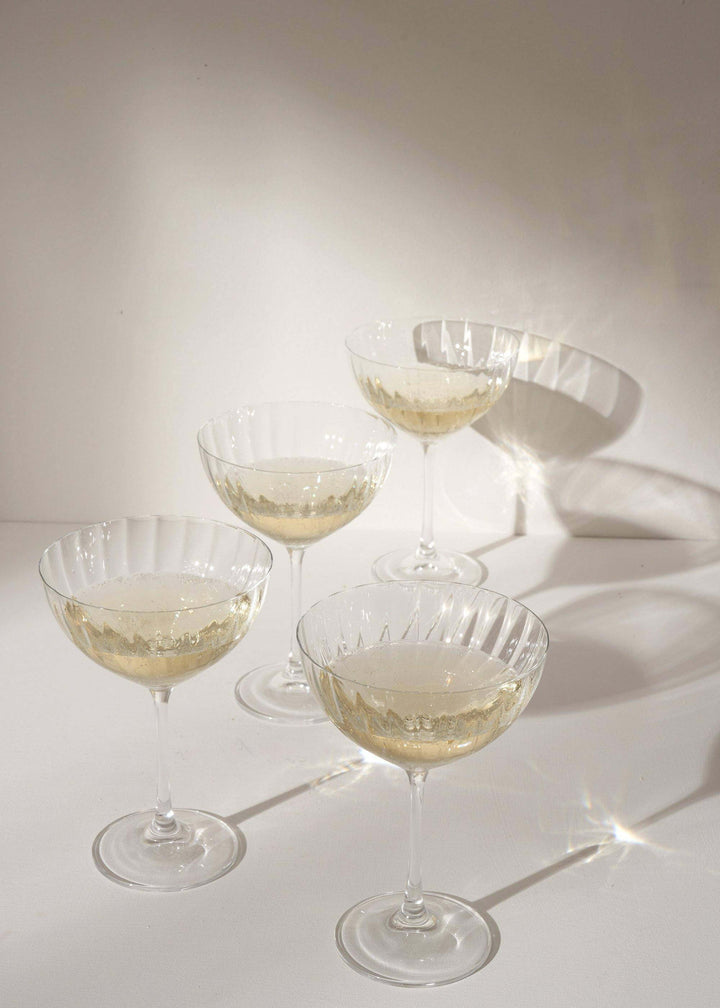 Set of four fluted coupe glasses with champagne in | Truly Lifestyle